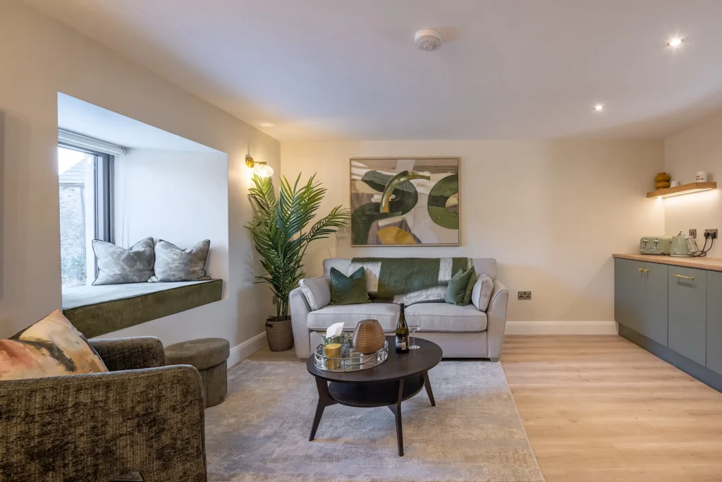 Tower Lodge living area with sofa, armchair and cushioned window seat